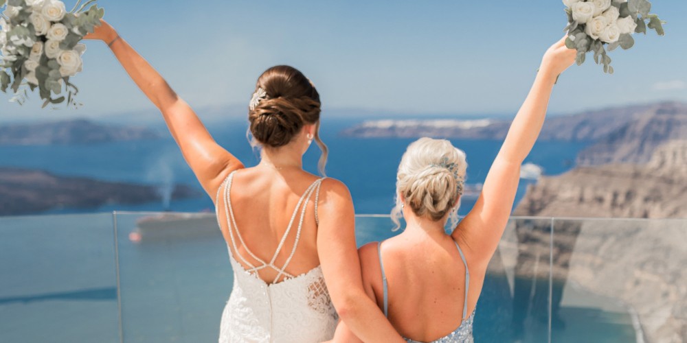 Bride and bridesmaid celebrating in Greece