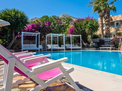 Pool area with sunbeds at Irini Hotel