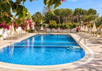 Pool sun loungers at Eleana Apartments